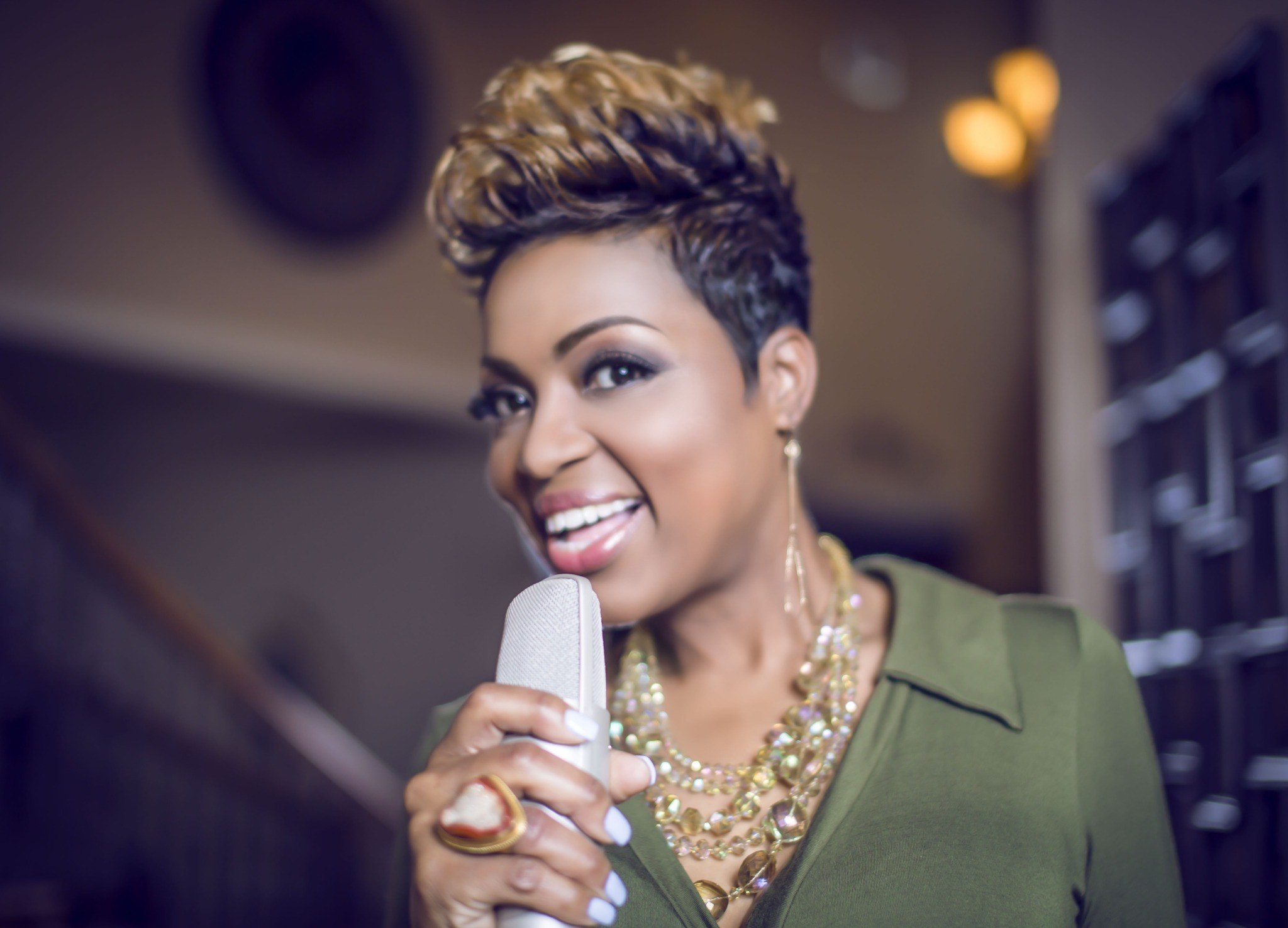 Cassandra Robertson smiling and holding a microphone